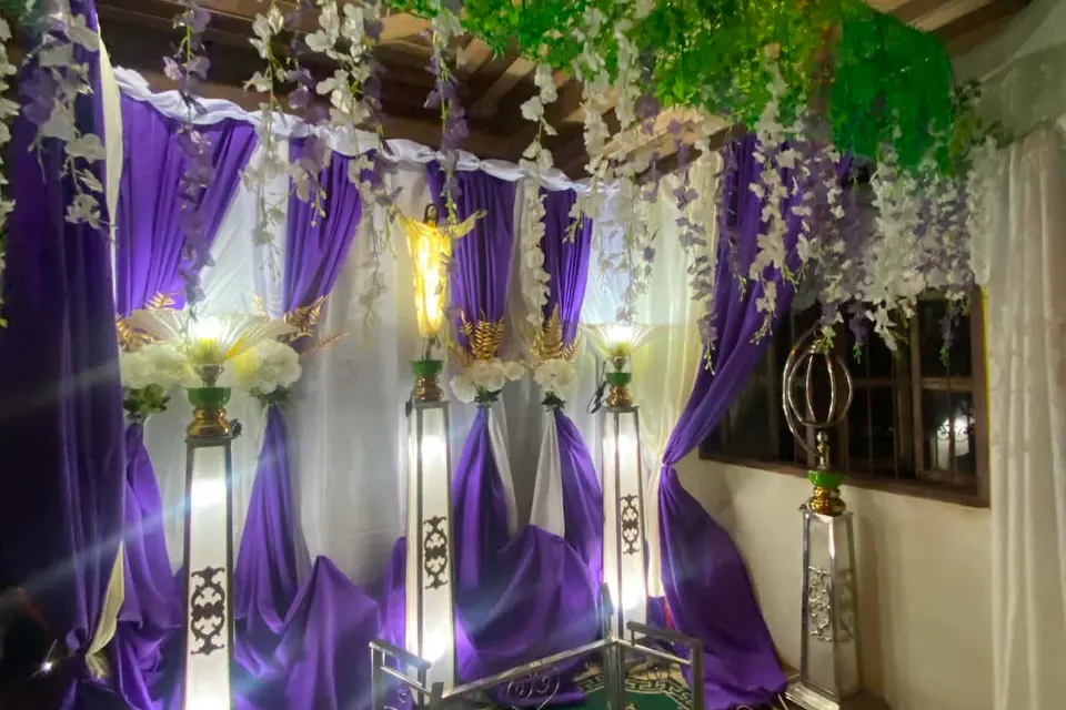 A decorated private viewing room in the client's own photograph — purple and white drapes, hanging flowers and lit lamp stands